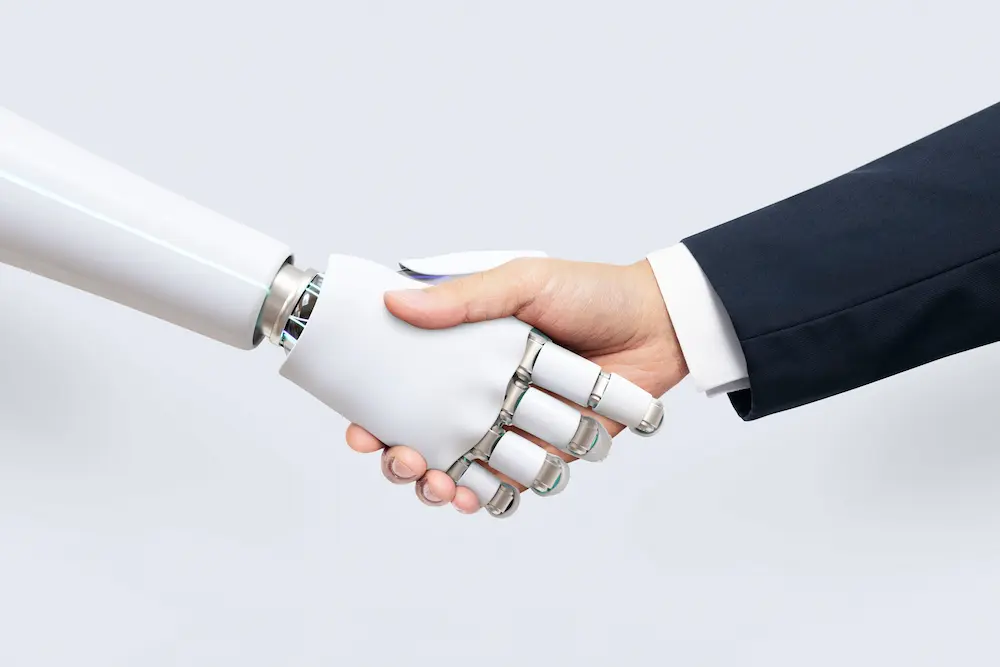 AI and human hand shaking in a digital environment