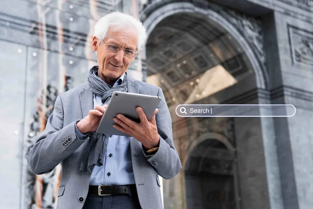 Man stands outdoors with tablet. A Google search bar is overlayed next to him